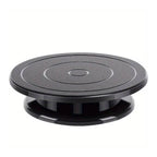 Rotating Cake Turntable Stand Black Plastic, showing a cake decorated with berries on a black plastic turntable.